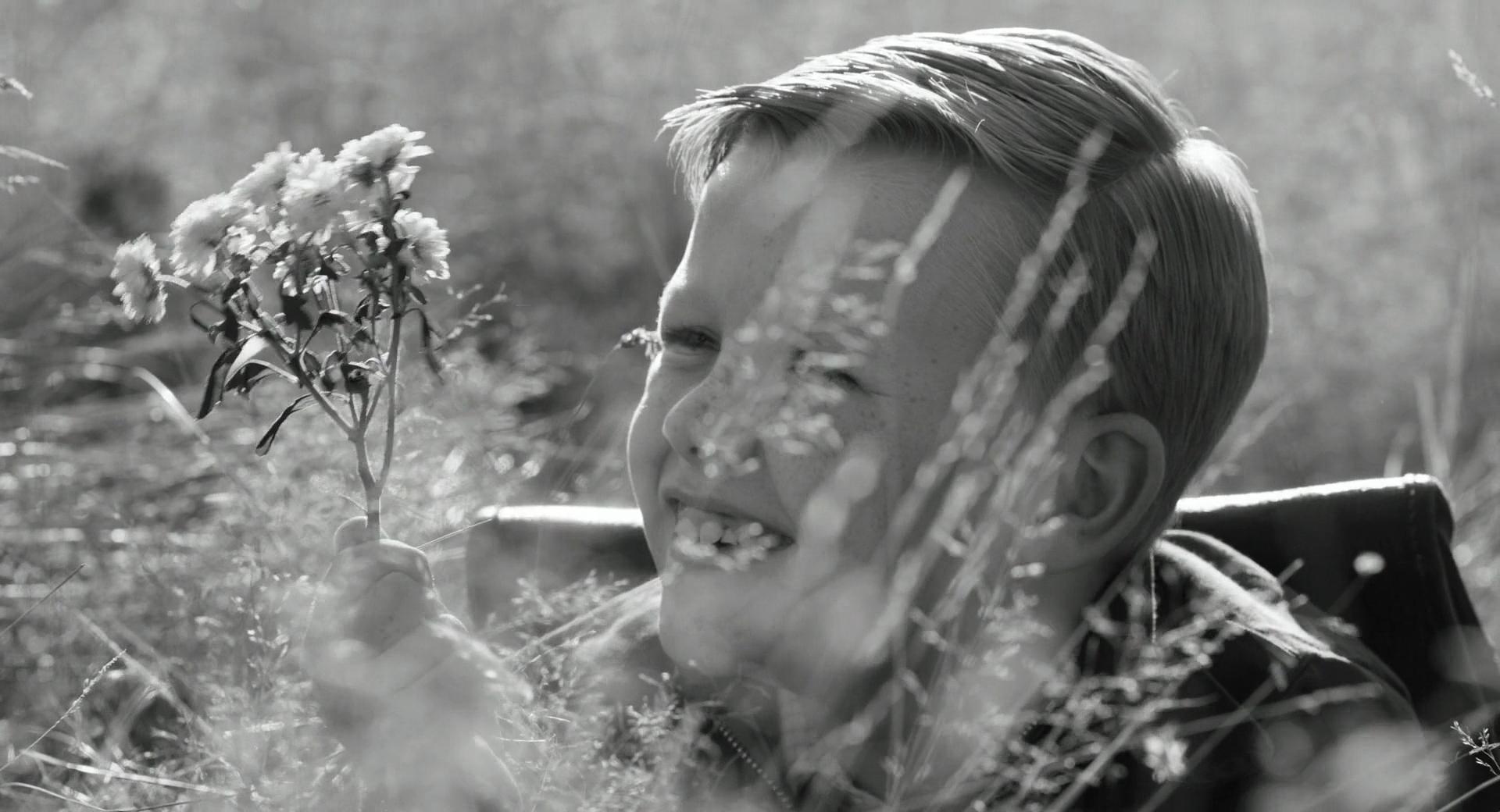 A child looks at some grass
