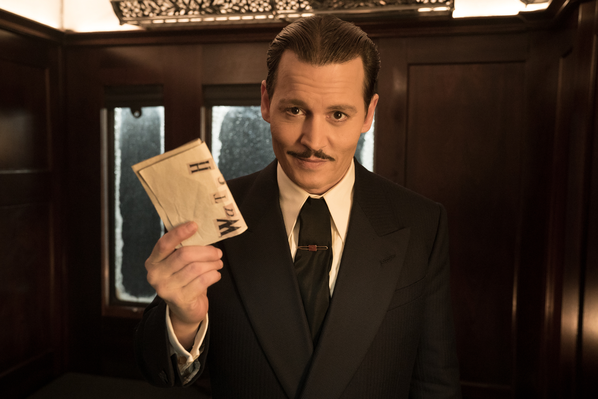 Depp holds a note