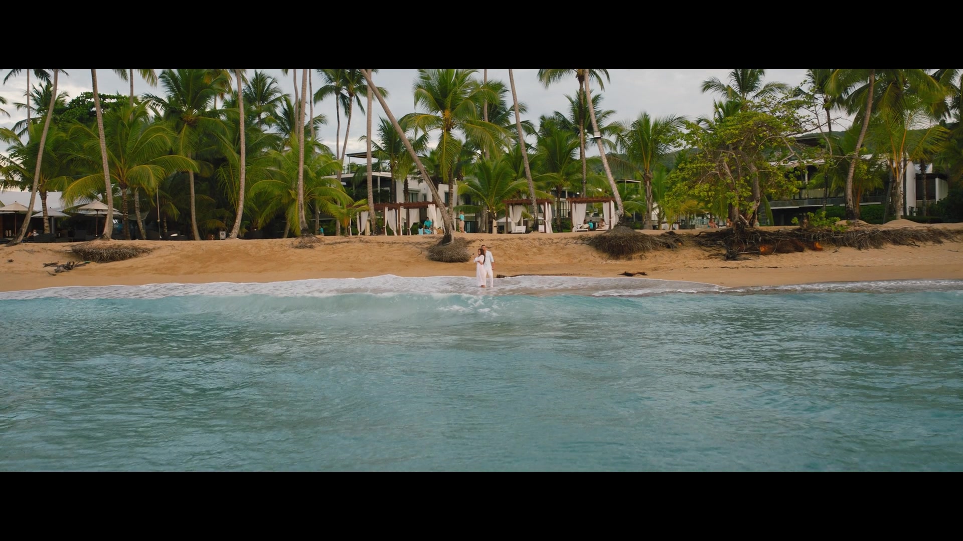The heroes stand on a sandy beach