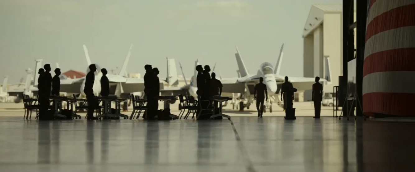 People sillhouetted against some planes