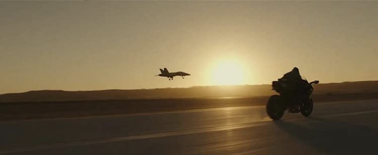Tom races a plane on his motorbike