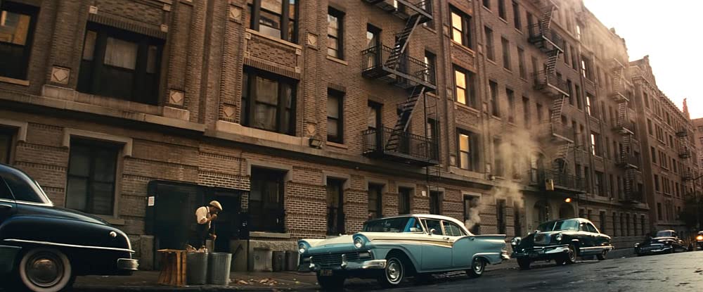A quiet streetscape with a couple of parked cars